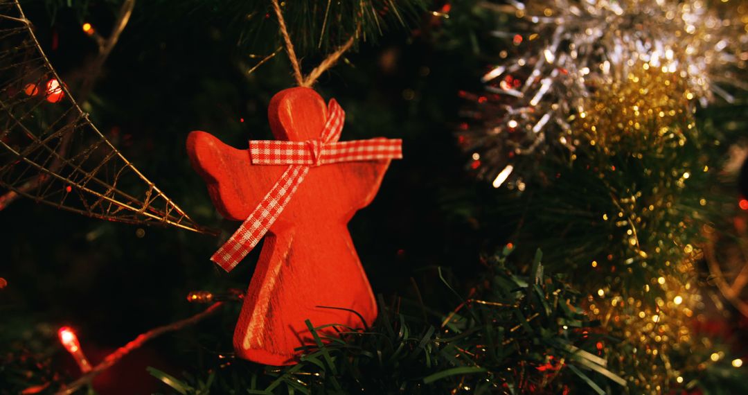 Handcrafted Red Christmas Angel Ornament on Tree - Free Images, Stock Photos and Pictures on Pikwizard.com