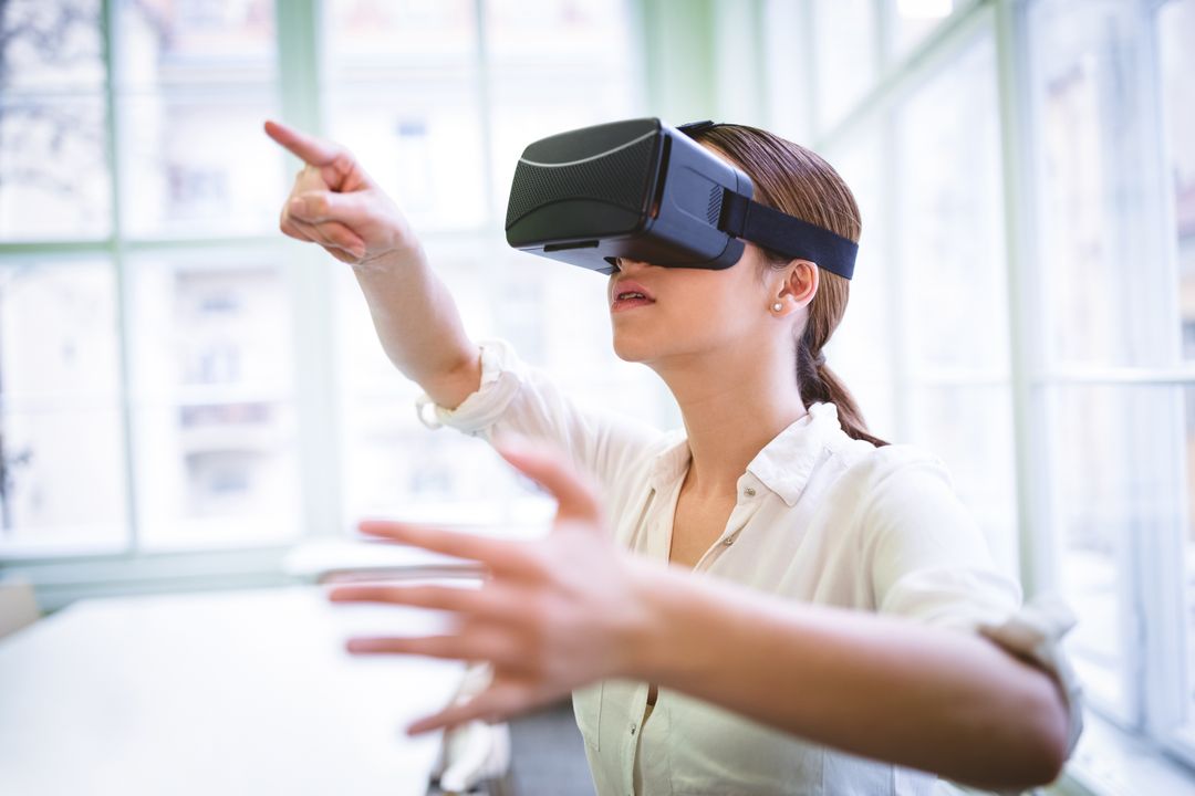 Graphic designer gesturing while using virtual reality headset - Free Images, Stock Photos and Pictures on Pikwizard.com