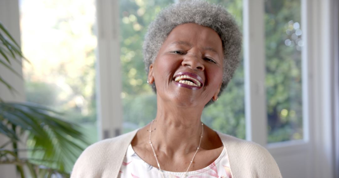 Smiling Elderly Woman Enjoying a Bright Day Indoors - Free Images, Stock Photos and Pictures on Pikwizard.com