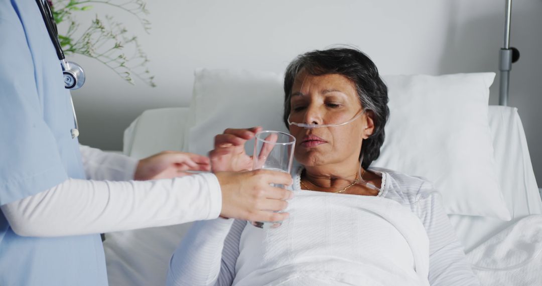 Nurse Assisting Elderly Woman in Hospital Bed - Free Images, Stock Photos and Pictures on Pikwizard.com