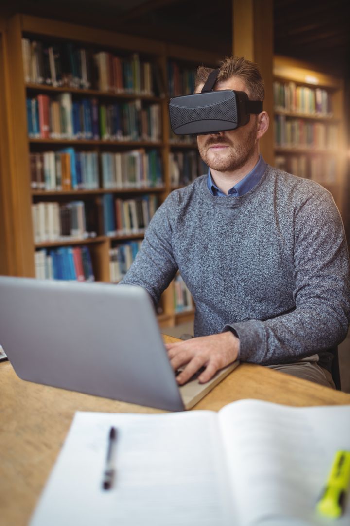 Mature student in virtual reality headset using laptop - Free Images, Stock Photos and Pictures on Pikwizard.com