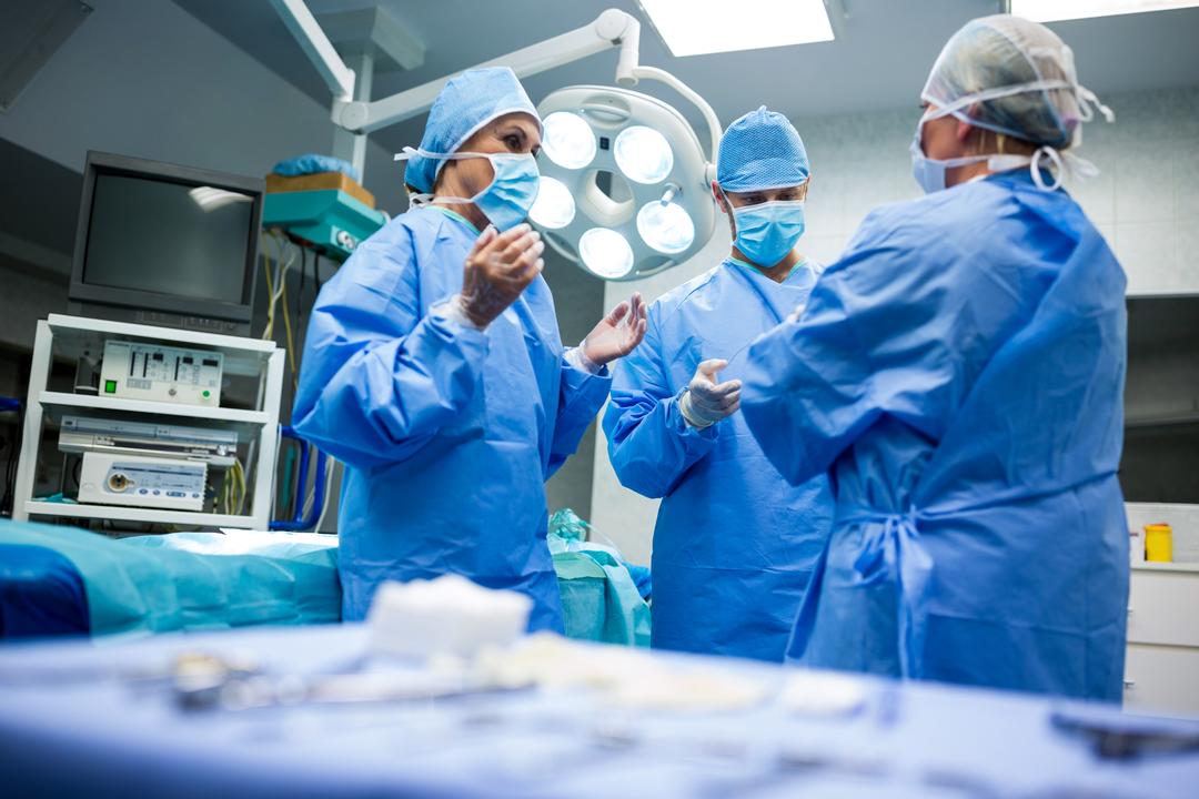 Surgical Team Communicating in Operating Room - Free Images, Stock Photos and Pictures on Pikwizard.com