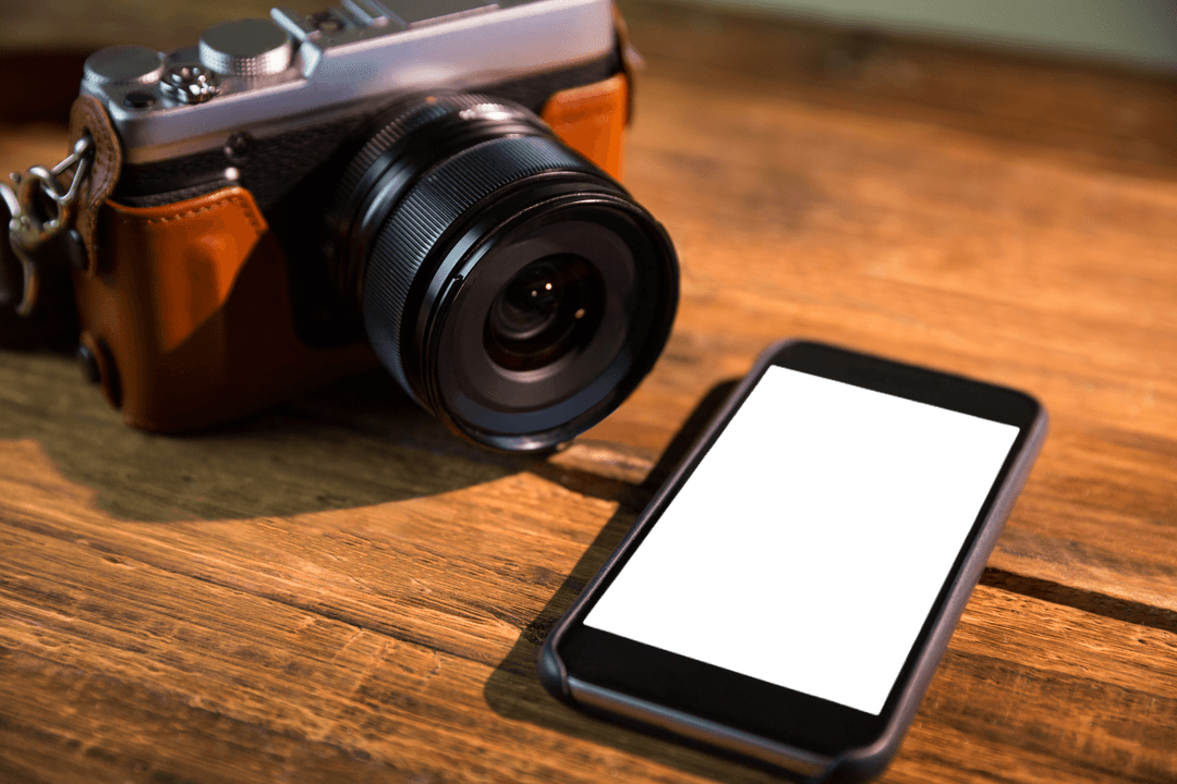 Transparent Modern Camera and Smartphone on Wooden Surface