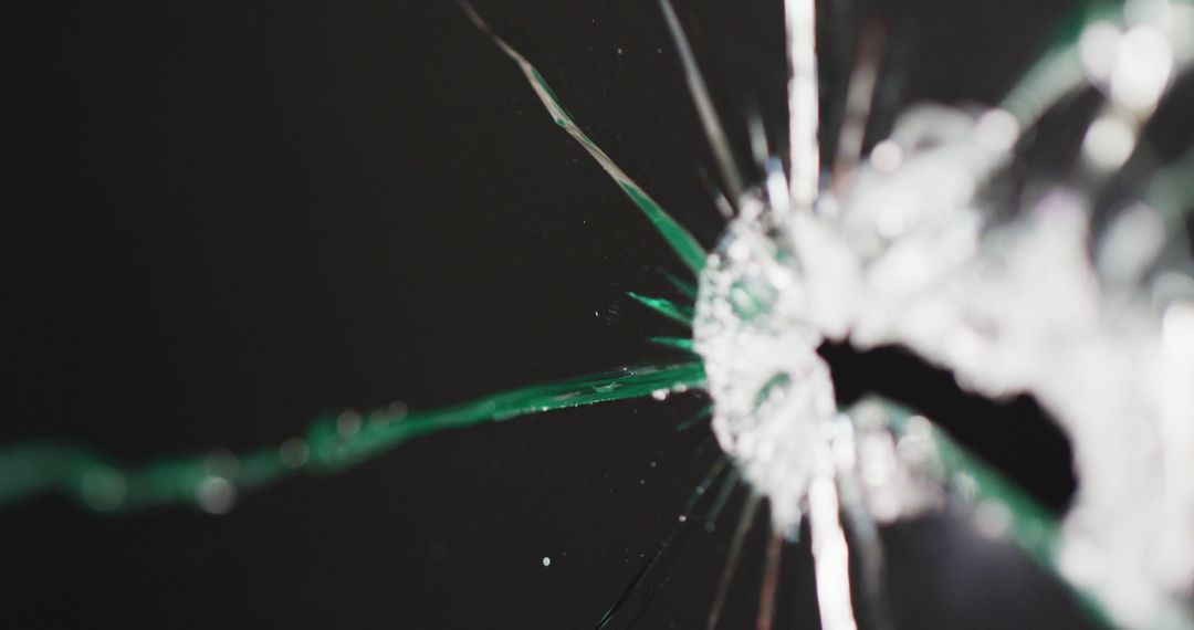 Close-up of Bullet Hole in Shattered Glass on Black Background - Free Images, Stock Photos and Pictures on Pikwizard.com