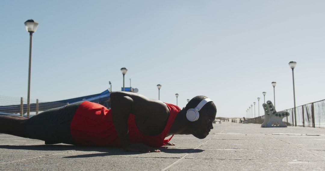 African American Man Doing Outdoor Push-Ups Listening to Music - Free Images, Stock Photos and Pictures on Pikwizard.com