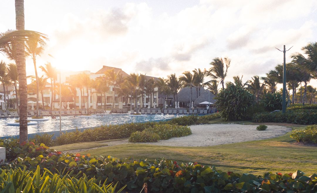 Tropical Resort Poolside at Sunset with Palm Trees