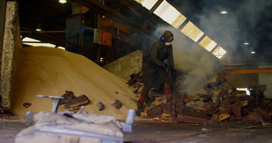 Worker Breaking Hot Mold in Industrial Foundry - Free Images, Stock Photos and Pictures on Pikwizard.com