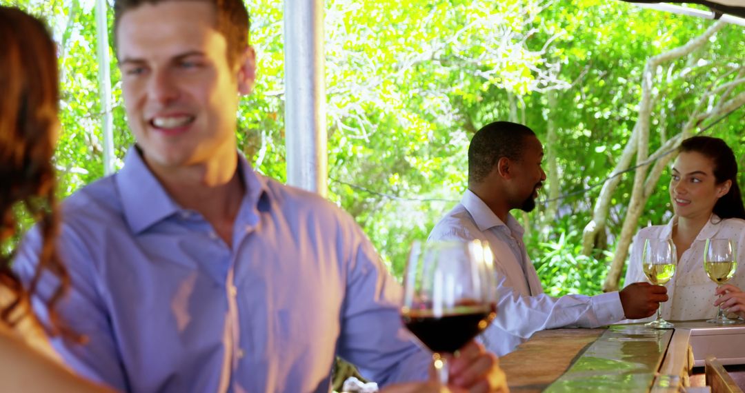 Diverse Group Enjoying Wine Tasting Amid Lush Vineyard Scenery