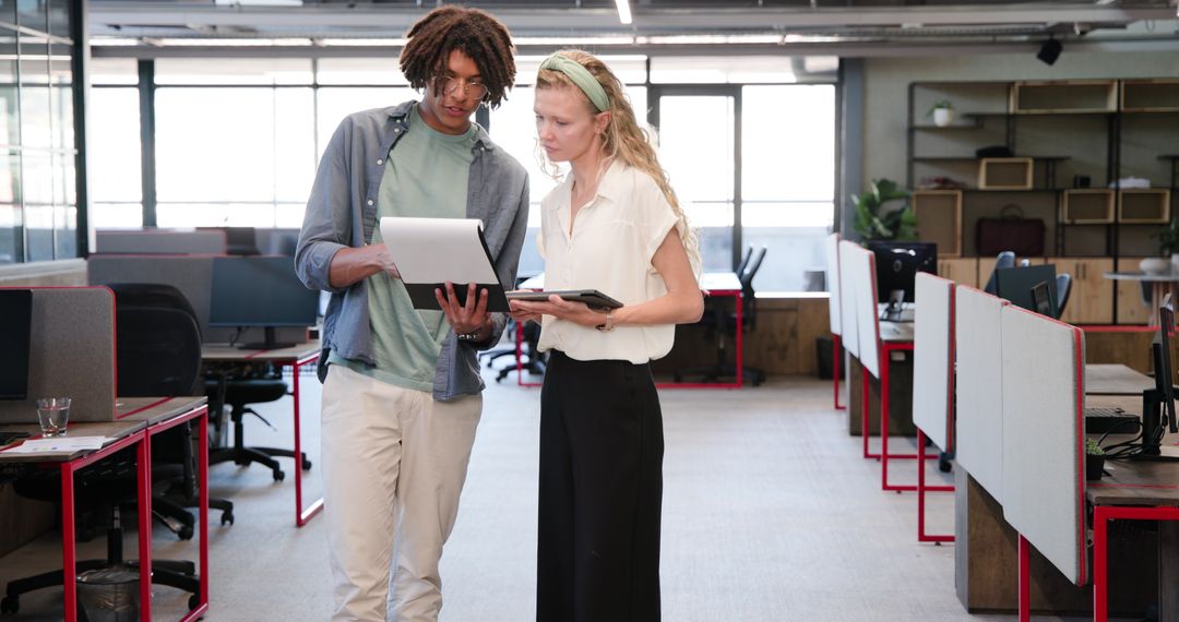 Colleagues Reviewing Documents in Collaborative Office Environment