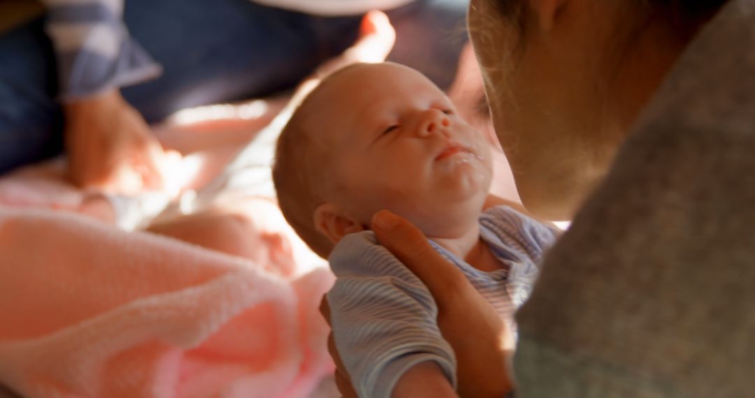 Loving Mother Cradling Newborn Baby in Warm Light - Free Images, Stock Photos and Pictures on Pikwizard.com