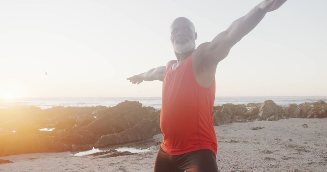 Senior man exercising at beach during sunrise - Free Images, Stock Photos and Pictures on Pikwizard.com