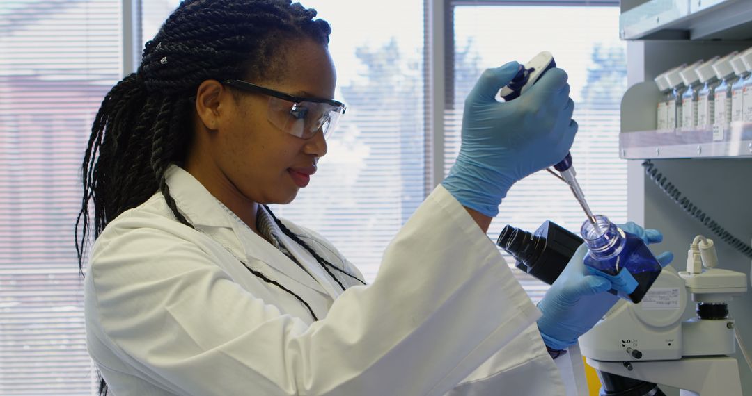 Determined Scientist Using Pipette in Modern Laboratory
