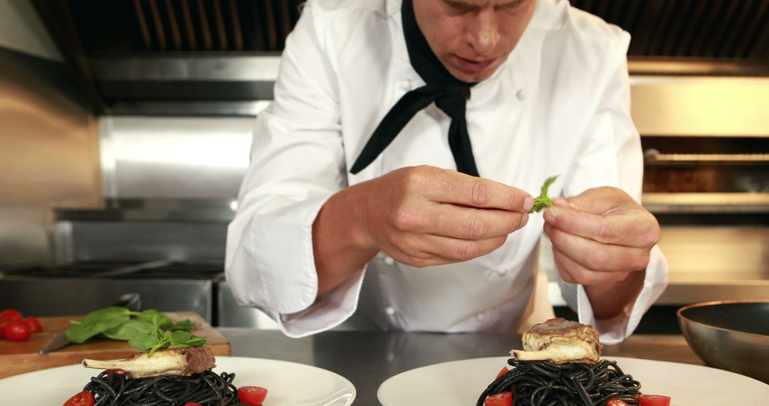 Chef plating gourmet pasta dish in professional kitchen - Free Images, Stock Photos and Pictures on Pikwizard.com