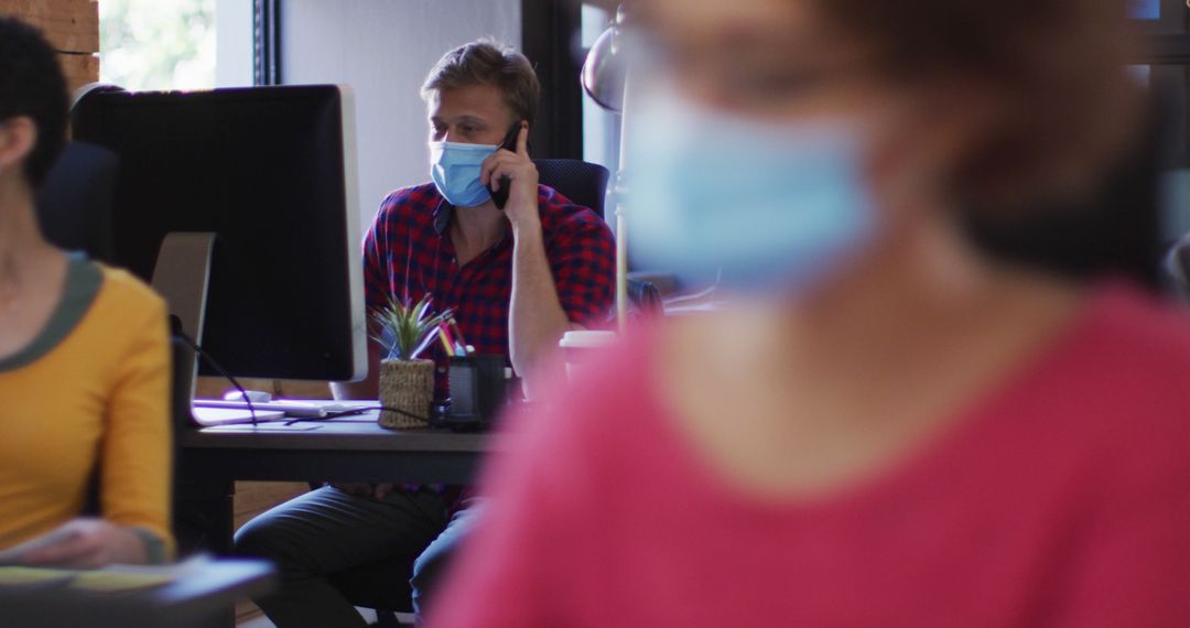 Employees in Open Office Wearing Face Masks and Working - Free Images, Stock Photos and Pictures on Pikwizard.com