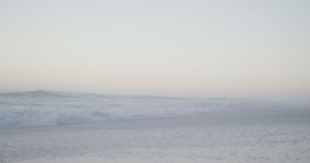 Serene Early Morning Beach with Gently Rolling Waves - Free Images, Stock Photos and Pictures on Pikwizard.com