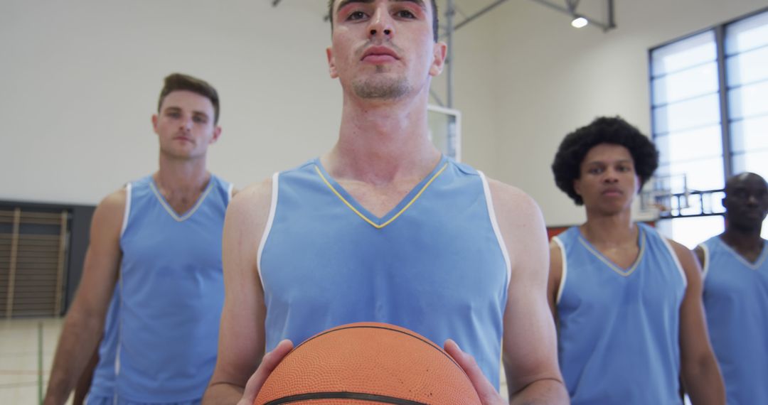 Basketball team with players in blue uniforms posing in indoor court - Free Images, Stock Photos and Pictures on Pikwizard.com