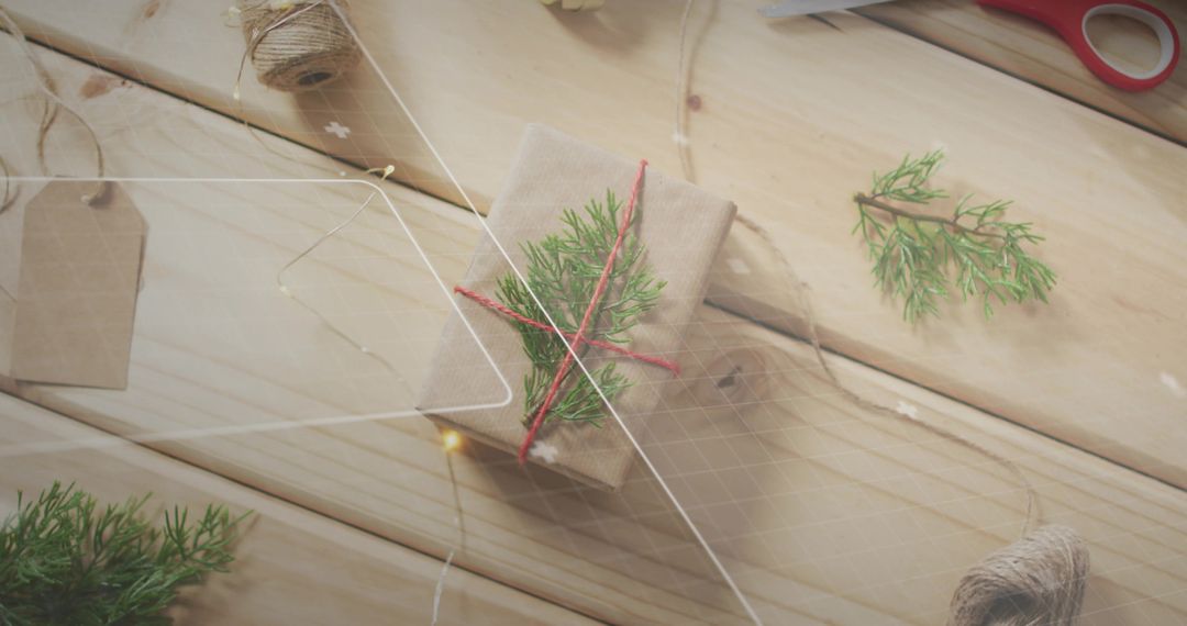 Kraft Gift Wrapping with Red Twine and Evergreen Sprig on Rustic Wood Tabletop