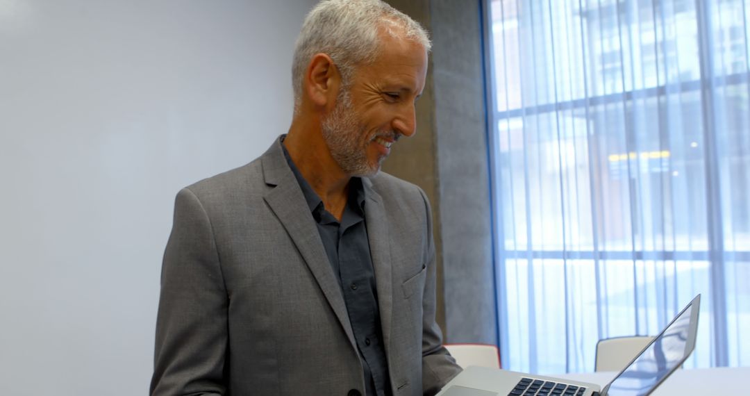 Businessman Working on Laptop Ensures Productivity in Office Environment