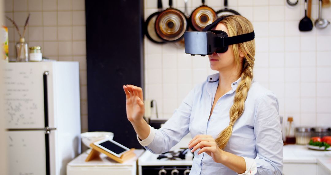 Woman Experiencing Virtual Reality with VR Headset in Kitchen - Free Images, Stock Photos and Pictures on Pikwizard.com