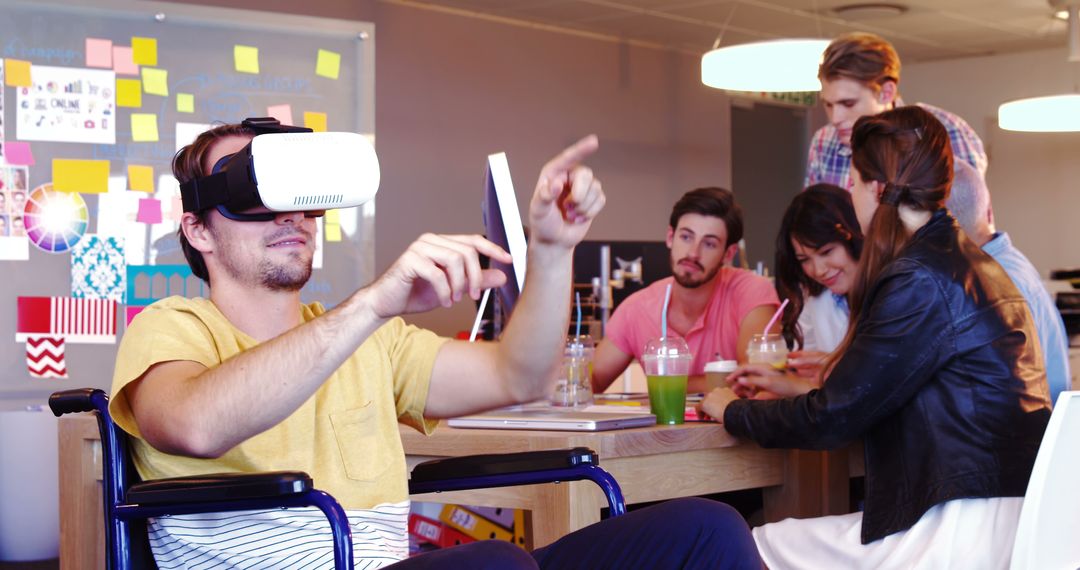 Young man in wheelchair using VR headset in modern collaborative workspace - Free Images, Stock Photos and Pictures on Pikwizard.com