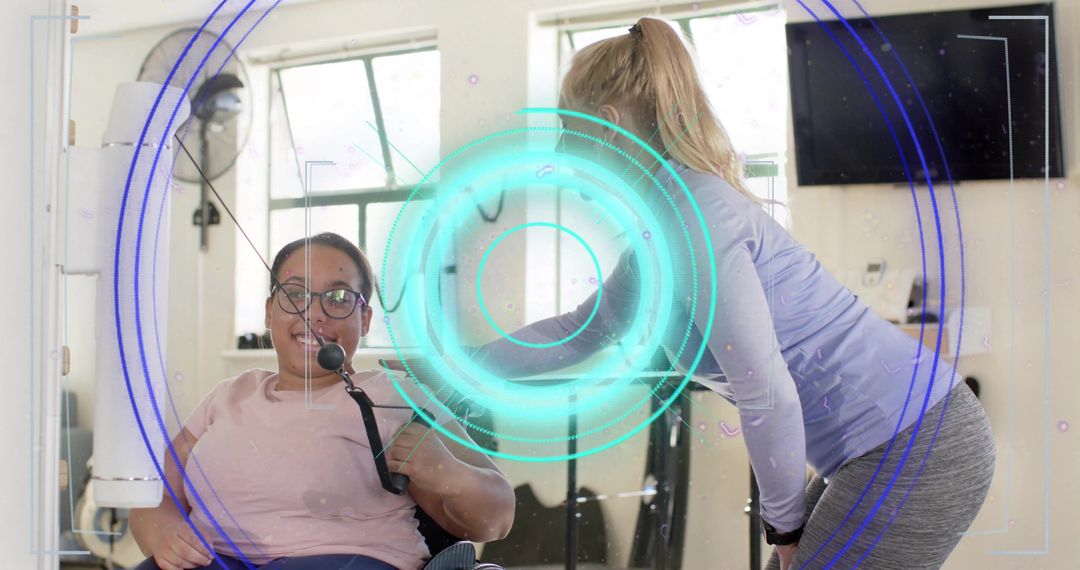 Trainer assisting wheelchair user during rehabilitation workout in bright gym studio