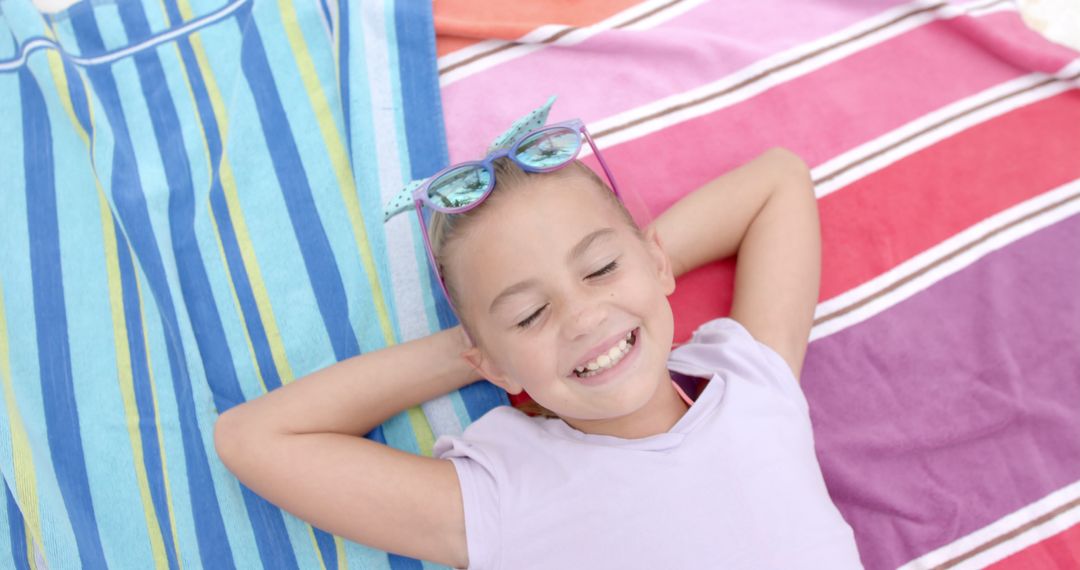 Smiling Girl Relaxing on Colorful Beach Towels - Free Images, Stock Photos and Pictures on Pikwizard.com