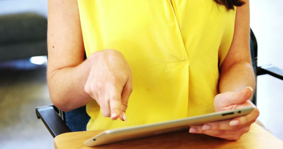 Woman in Yellow Shirt Using Digital Tablet - Free Images, Stock Photos and Pictures on Pikwizard.com