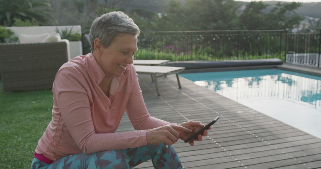 Active Senior Woman Using Smartphone by Poolside - Free Images, Stock Photos and Pictures on Pikwizard.com