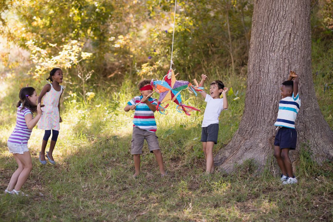 Children Playing with Pinata in Forest - Free Images, Stock Photos and Pictures on Pikwizard.com