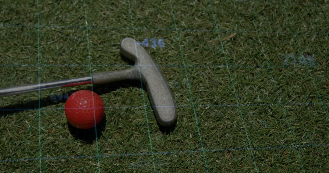 Golf Putter and Ball on Green with Alignment Grid for Precision Practice