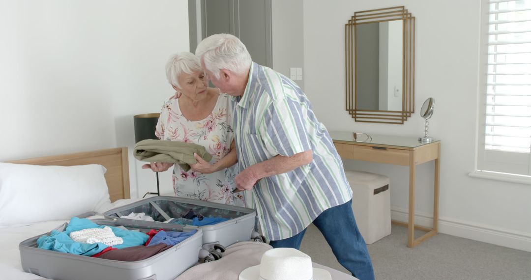 Senior Couple Packing Suitcase for Vacation in Modern Bedroom - Free Images, Stock Photos and Pictures on Pikwizard.com