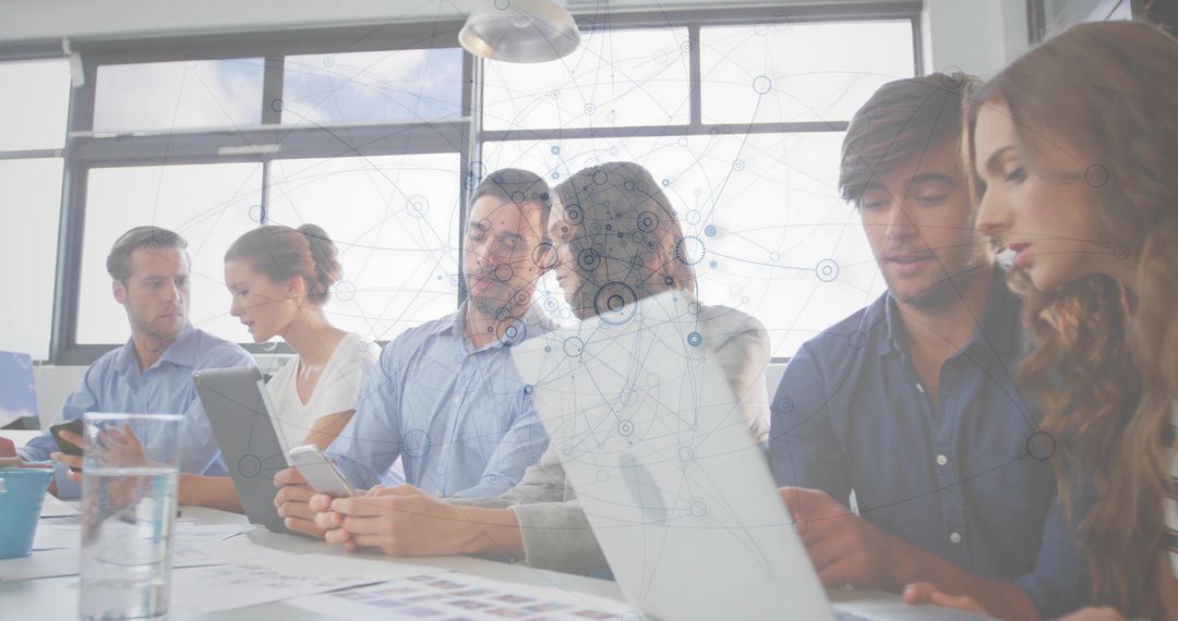 Team Collaborating on Digital Devices in Modern Office with Data Network Overlay