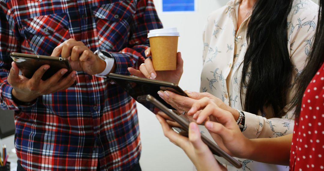 Diverse Team Collaborating Using Tablets in Creative Office