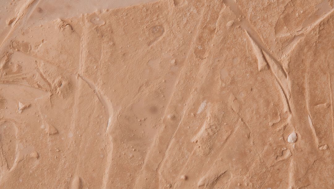 Beige Cream Texture Macro With Smear Marks, Ridges and Granular Paste Details