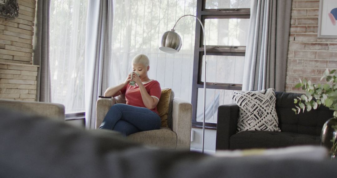 White-Haired Woman Enjoying Coffee in Modern Living Room - Free Images, Stock Photos and Pictures on Pikwizard.com