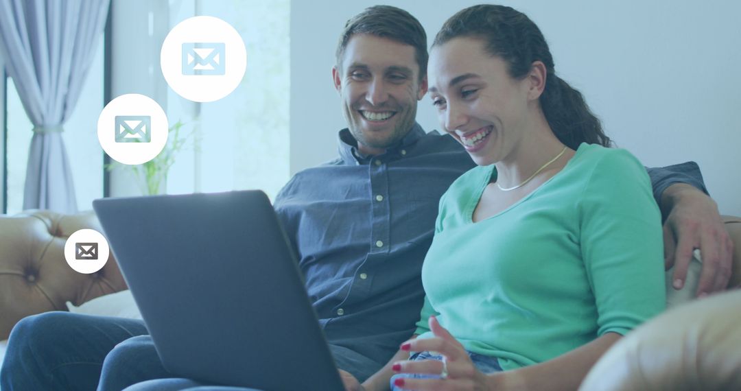 Smiling Couple Engaging with Emails on Laptop