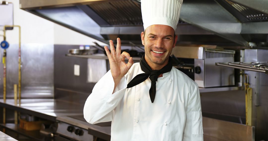 Male Chef Showing Okay Gesture in Professional Kitchen - Free Images, Stock Photos and Pictures on Pikwizard.com