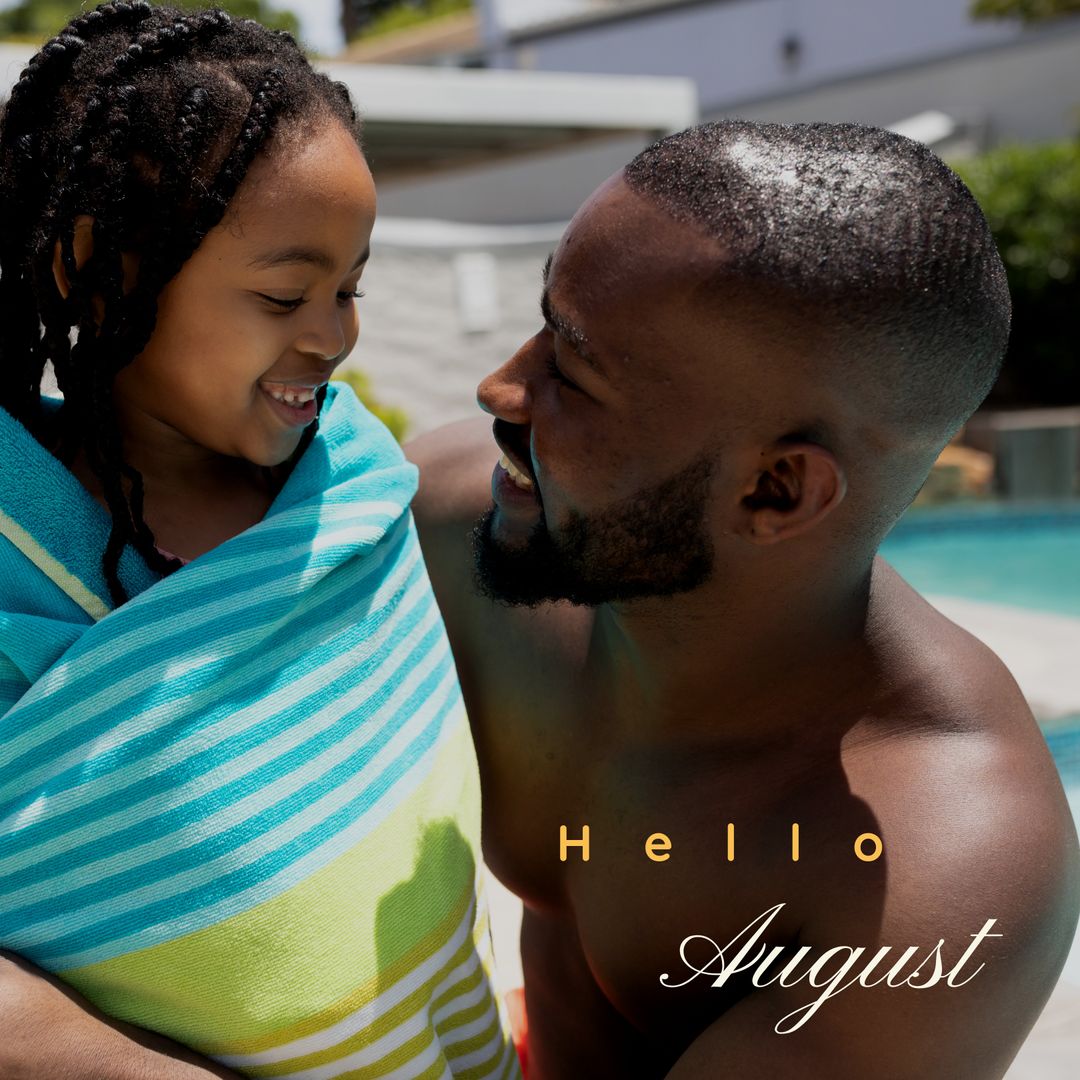 Father Wrapping Daughter in Towel at Poolside During Summer