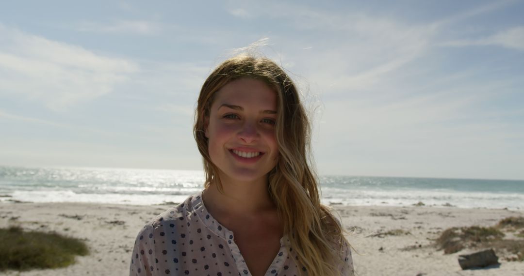 Young Woman Smiling by the Beach on a Sunny Day - Free Images, Stock Photos and Pictures on Pikwizard.com