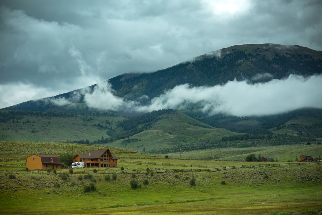 Rural Countryside Cabin with Misty Mountain and Cloudy Sky - Free Images, Stock Photos and Pictures on Pikwizard.com