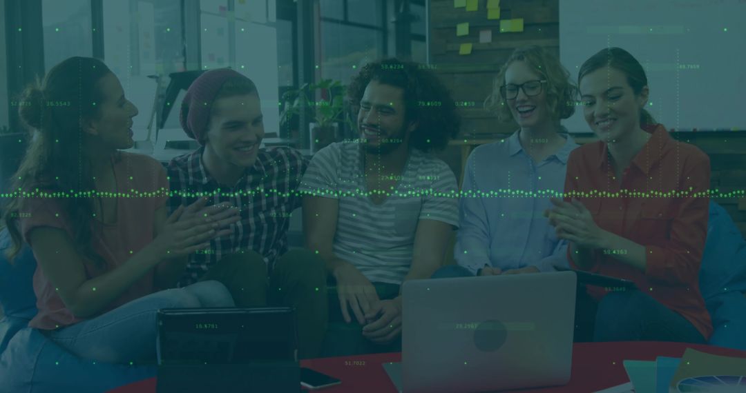 Creative Team Collaborating in Modern Workspace with Technology