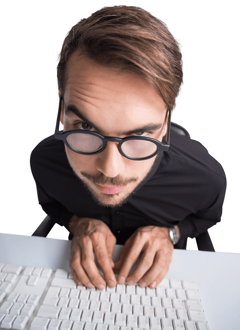 Suspicious Young Man with Glasses Typing on Keyboard Isolated on Transparent Background