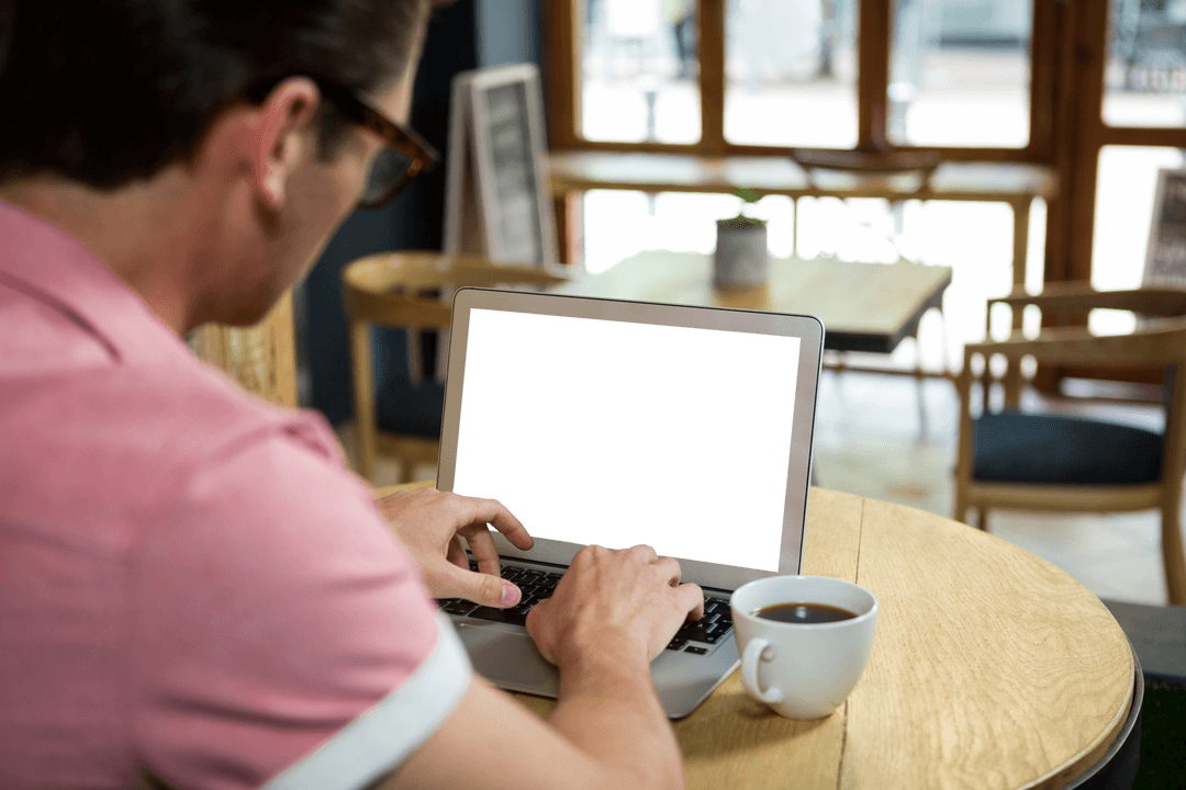 Man using laptop with transparent screen in cozy cafe