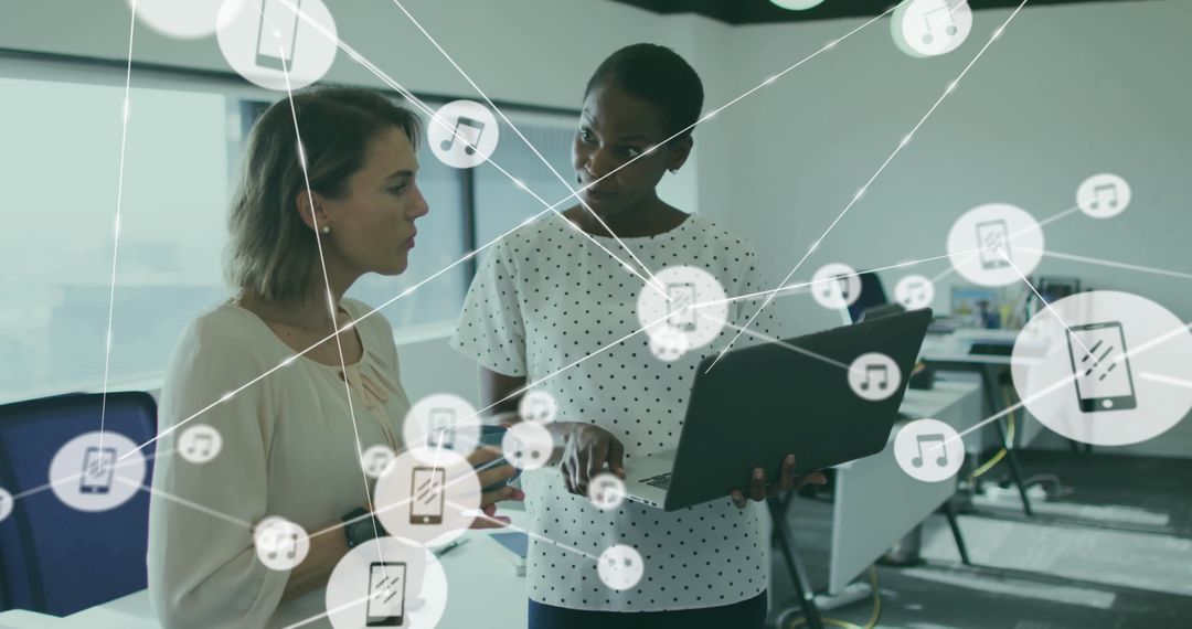 Professional Women Collaborating in Modern Workspace with Digital Connectivity