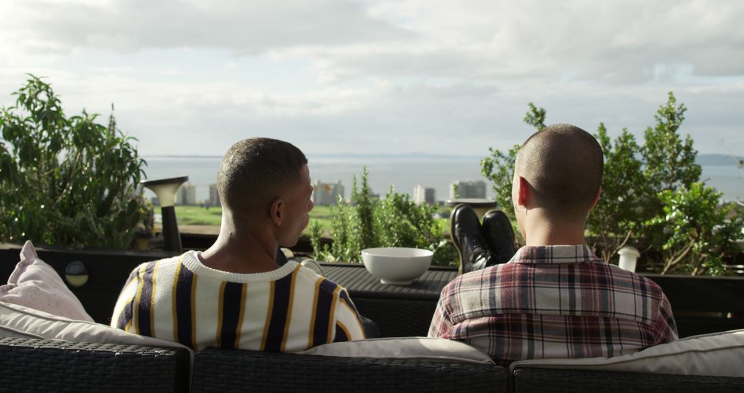 Couple Relaxing on Outdoor Patio Overlooking Scenic Cityscape - Free Images, Stock Photos and Pictures on Pikwizard.com