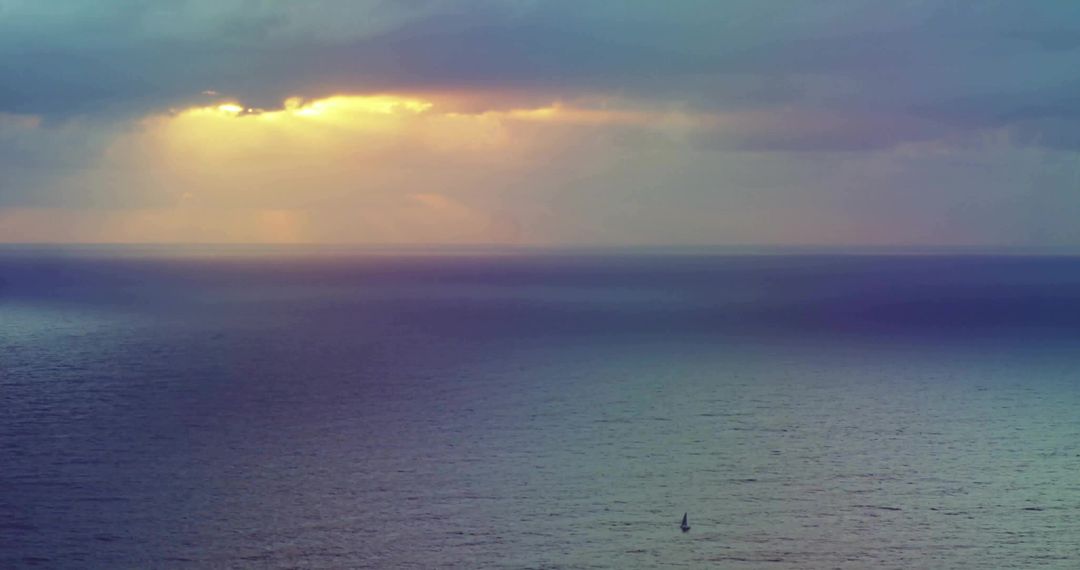 Sailboat Navigating Ocean Under Golden Sunset Reverie