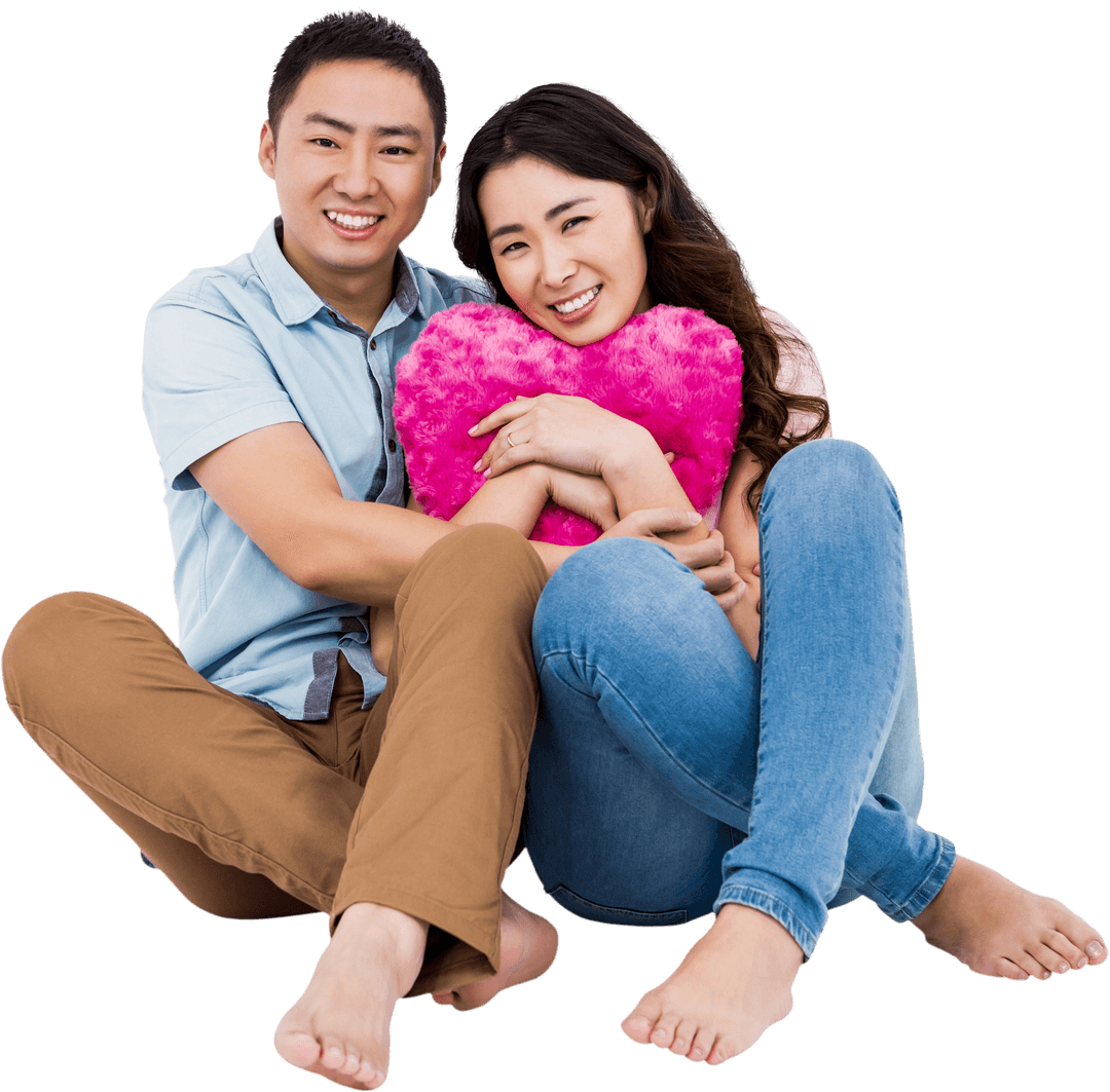 Smiling Couple with Heart-Shaped Pillow Embracing Joy Transparent