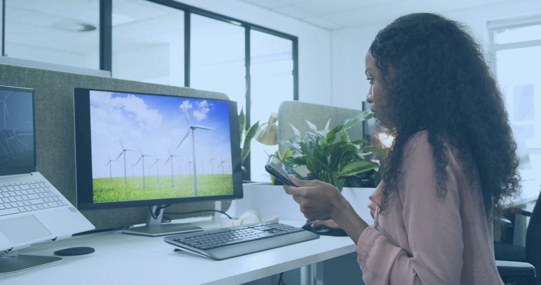 Businesswoman Exploring Sustainable Technology in Modern Office