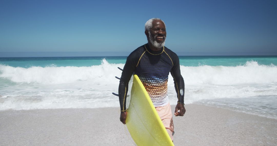 Senior Man Enjoying Surfing at Beach on Sunny Day - Free Images, Stock Photos and Pictures on Pikwizard.com