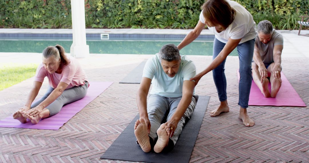 Group Practicing Yoga Led by Instructor in Outdoor Setting